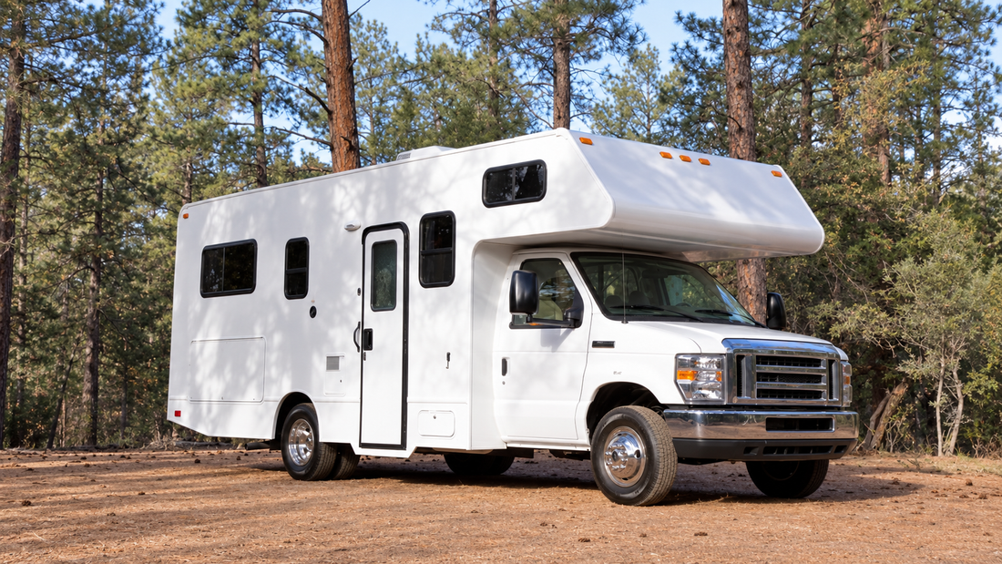 Class C motorhome parked at a wooded campsite, representing an RV rental that can be monitored with a GPS tracker.